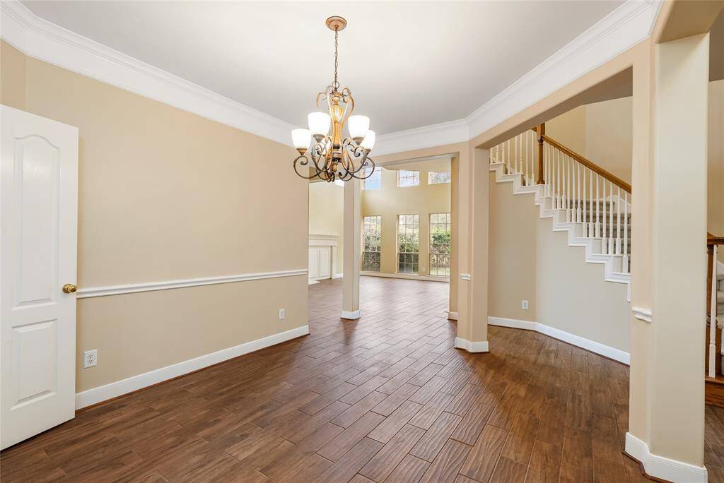 The dining room flows seamlessly to the adjacent breakfast area, kitchen, and living room for easy entertainment.