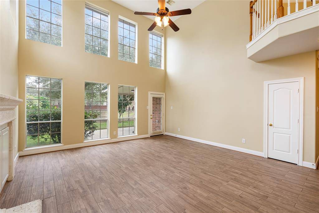 Another vantage point of the living room showcases the neutral paint and scenery. There is a closet under the stairs, where the owners added shelving for extra storage.