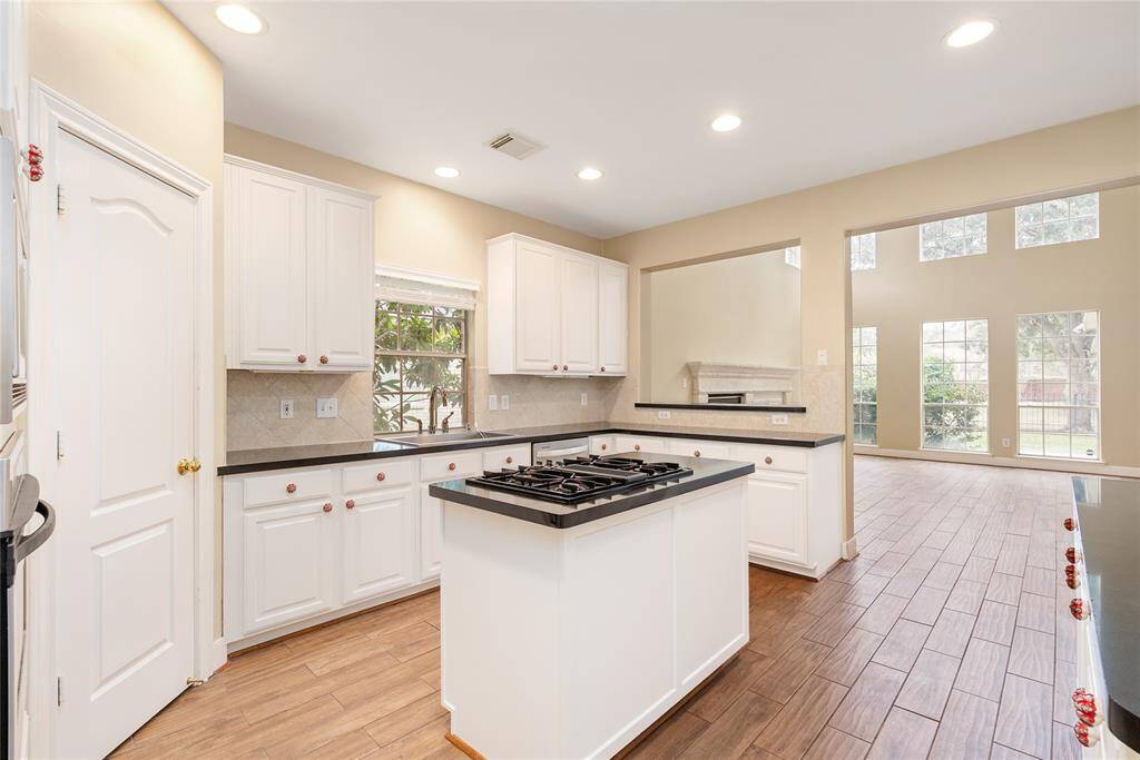 Everyone feels included with the kitchen anchoring the living, dining, and breakfast areas.