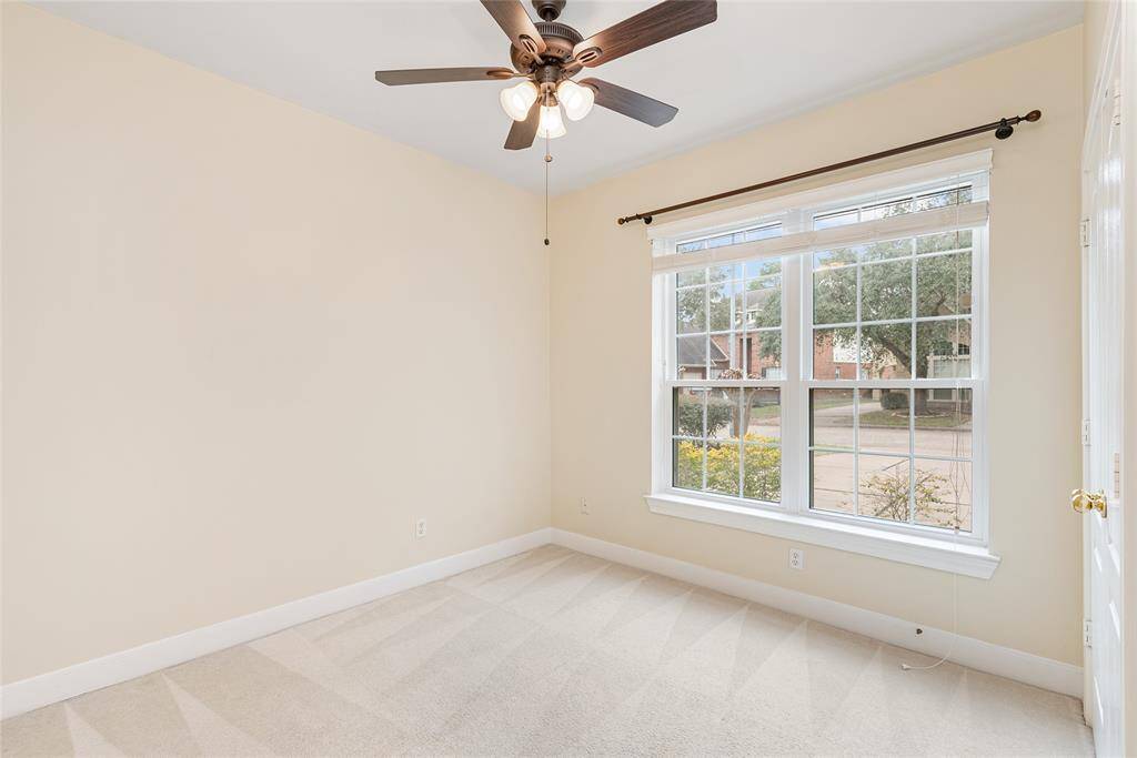 Before heading upstairs, let's take a look at the crepe myrtles and mature trees from one of the secondary bedrooms, which can also be used as an office. Every view in this house is stunning!
