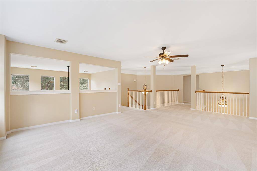 Now we head upstairs to the expansive game/flex/family room, which overlooks the mature trees, breathtaking lake, and pool.