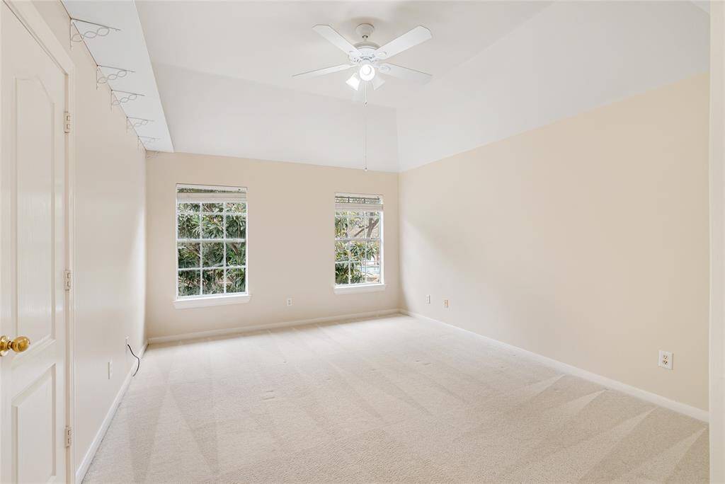 One of the three spacious upstairs bedrooms; this one overlooks the trees, lake, and pool.