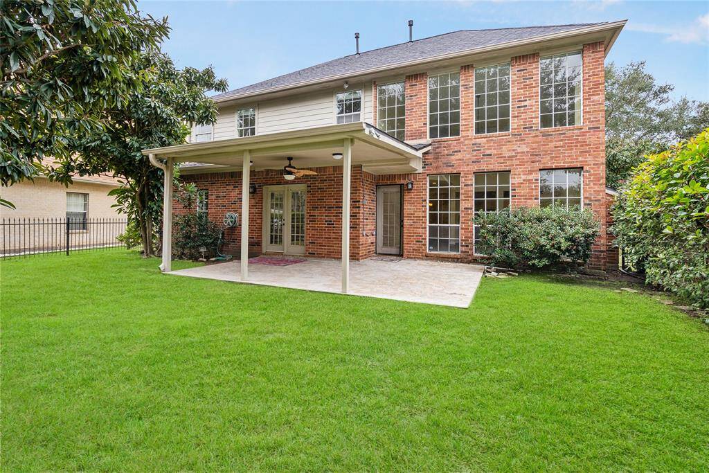 The owners added a large covered patio with beautiful tile, lighting, and a ceiling fan for an additional entertainment area, along with an uncovered area to soak in the rays.
