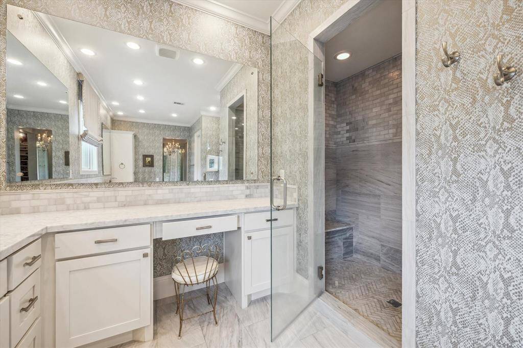 Large walk-in shower with bench and vanity area.  Please notice the designer wallpaper.