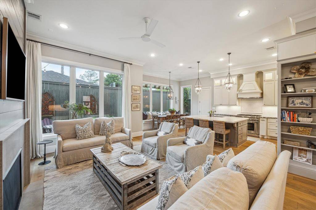Walls of windows bring in natural light to the lovely open-concept "heart of the home"