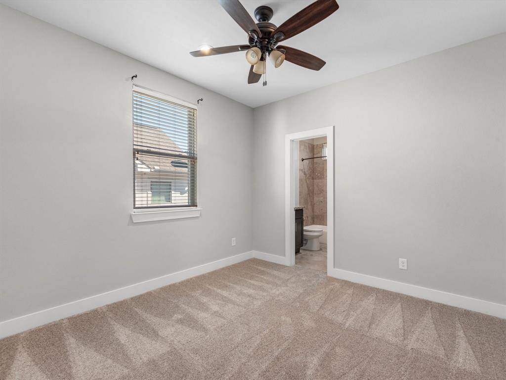 This well-appointed third-floor secondary bedroom offers both comfort and convenience with its own private ensuite bath. Featuring plush carpeting, a large window for natural light, and a ceiling fan for added comfort, this space is perfect for guests, a home office, or a personal retreat. The ensuite bathroom boasts stylish tile finishes and modern fixtures, providing a sleek and functional design. A versatile and inviting space in the heart of The Heights!