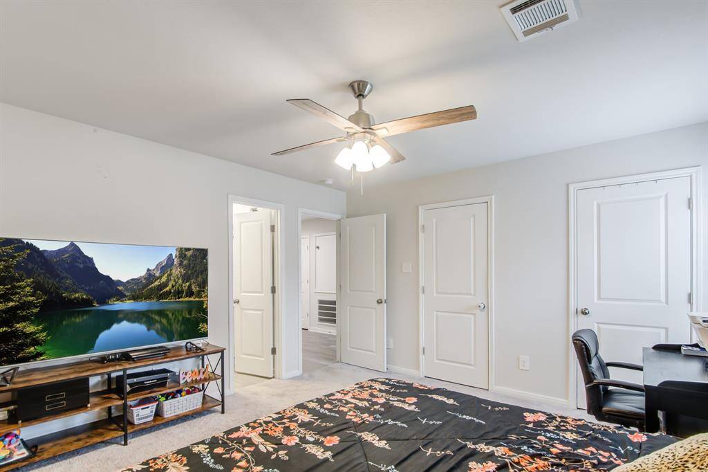 Another view of primary bedroom that leads into a private bathroom.