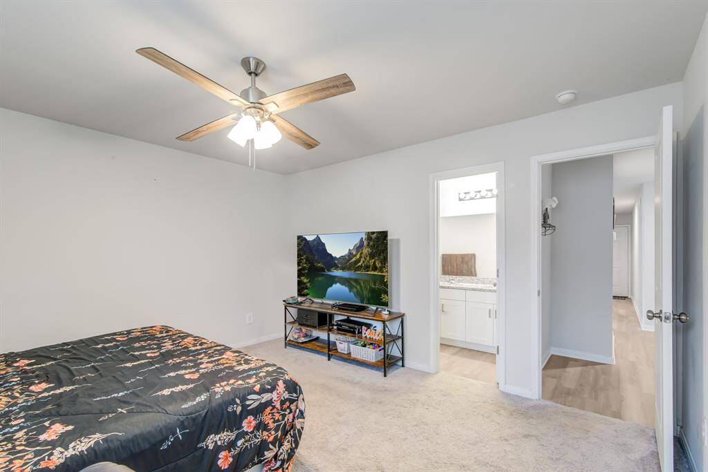 Another view of primary bedroom that leads into a private bathroom.