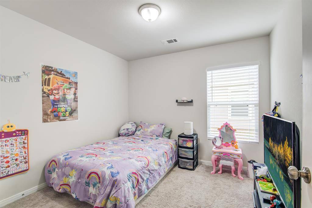 This is a cozy, well-lit secondary bedroom.
