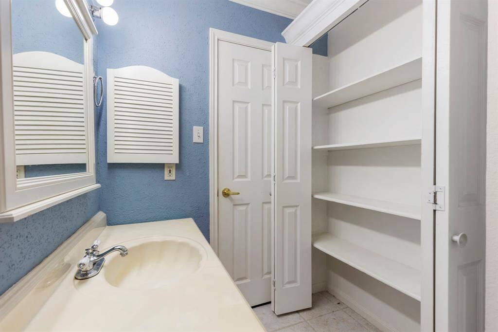 The full bath is accessible to the hallway and bedroom - plenty of storage.