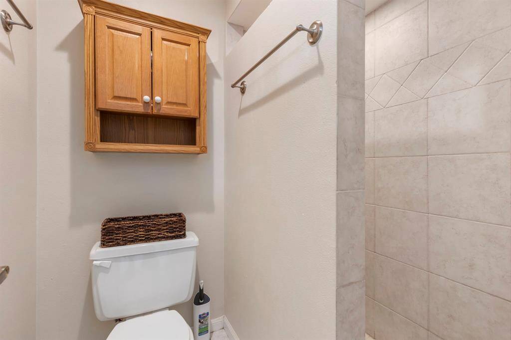 A large walk-in shower with tile surround can be found in the full bath.