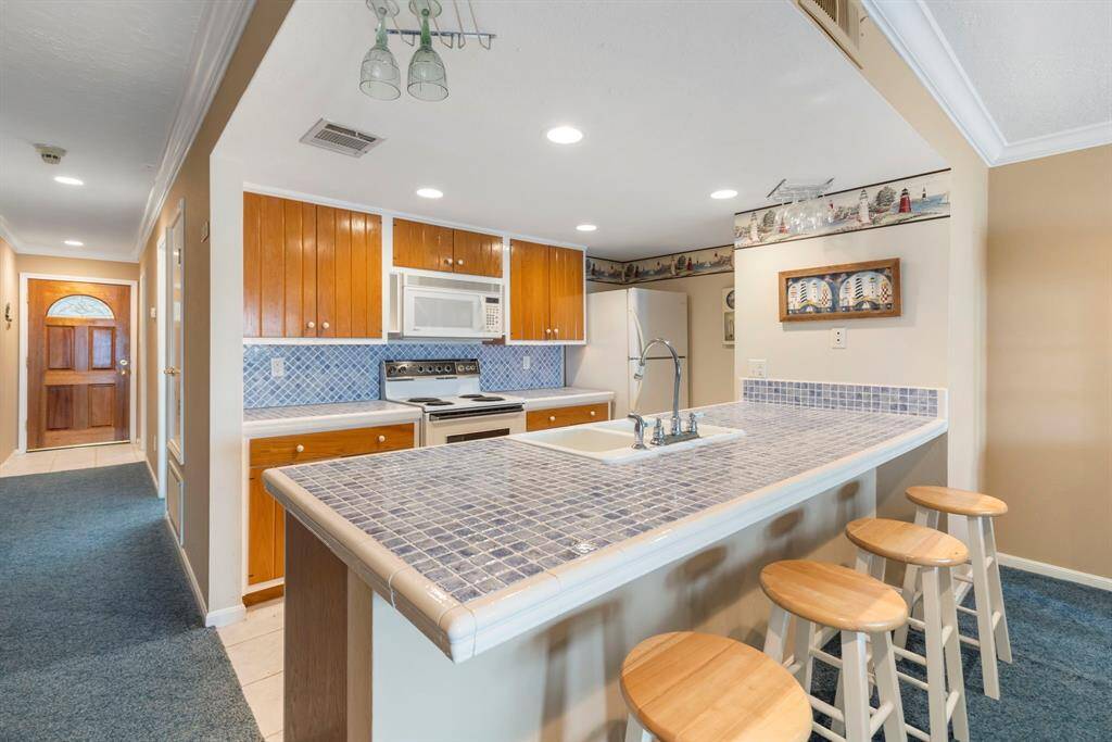 The kitchen is designed for with a breakfast bar and plenty of counterspace.