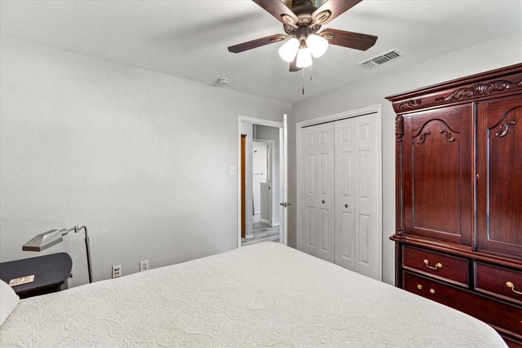 Another secondary bedroom with freshly painted walls and new flooring.