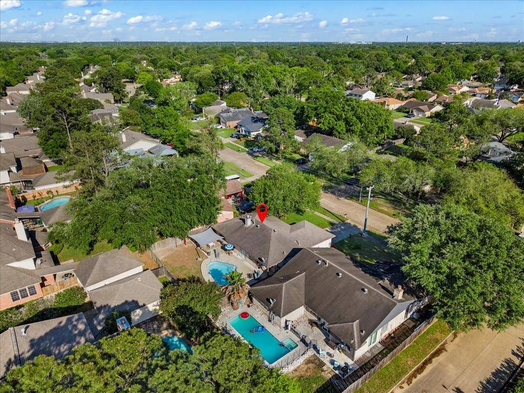 Aerial view of the home.  Lots of trees throughout the neighborhood.