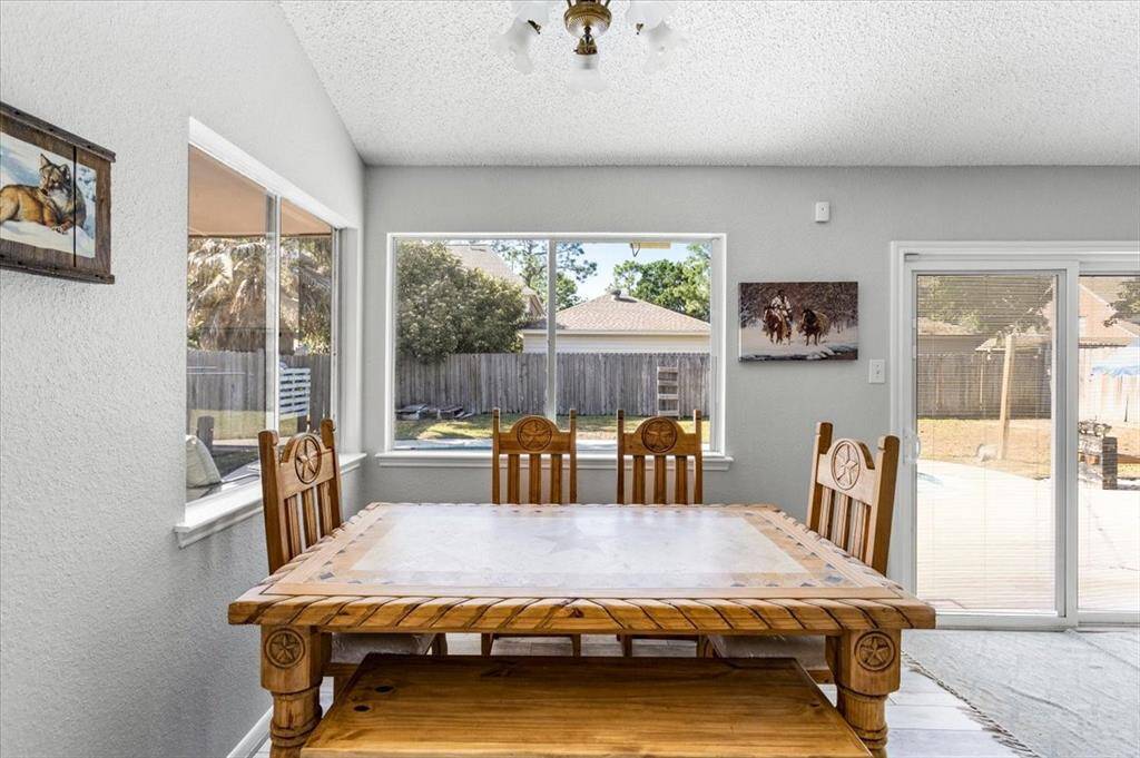 Dining area with views of the backyard and open to the family room.
