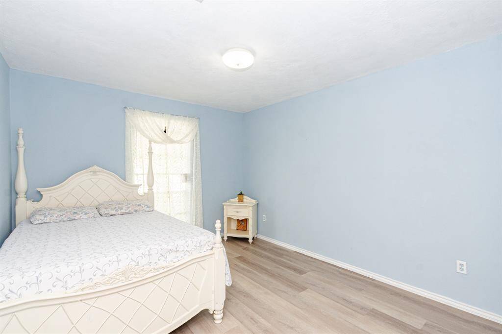 Large secondary bedroom with double closets.  New paint and new floors thoughout