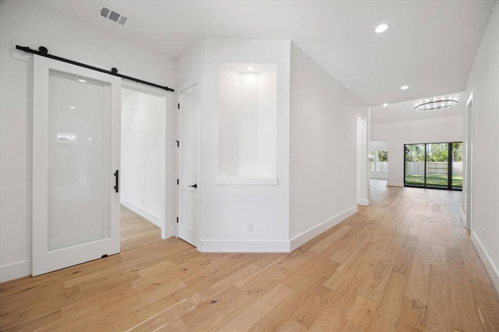 Foyer features display niche with spotlight. Study, with sliding barn door, off Foyer.