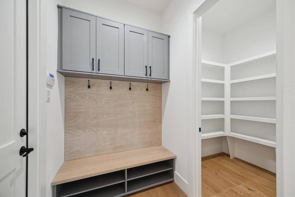 Mud Room with built-ins and custom cabinetry and view of Pantry