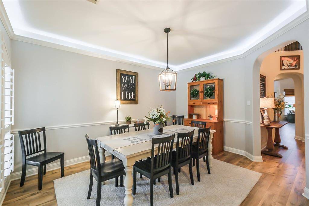 Another view of the dining room. Notice the crown molding and the Plantation shutters on the front windows.