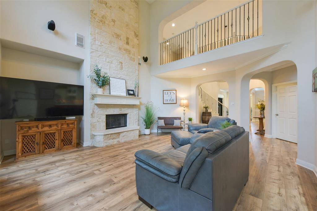Large, cozy family room with an impressive floor-to-ceiling limestone fireplace.