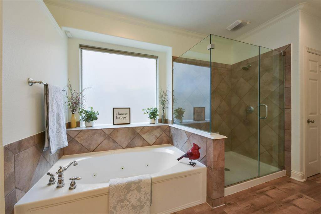 Jetted, spa tub along with a huge separate glass shower! This primary bathroom also offers 2 closets.
