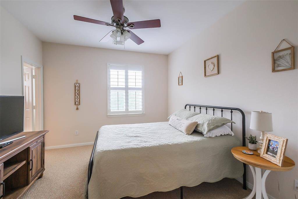 One of 3 large upstairs secondary bedrooms. Notice the classic Plantation shutters. Each bedroom has a huge walk-in closet.