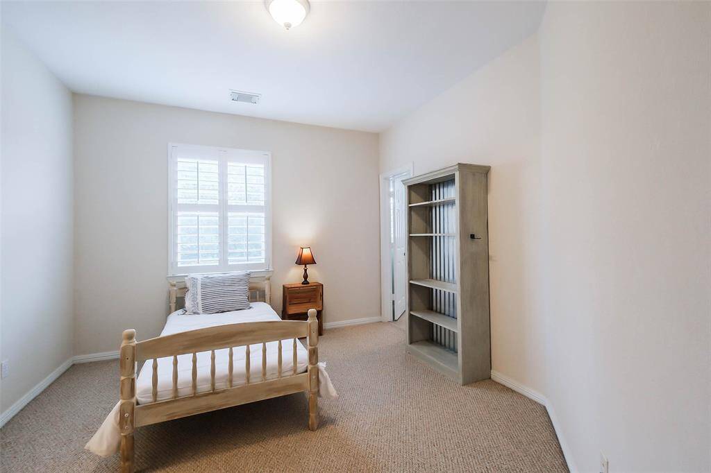 Another great-sized secondary upstairs bedroom. Again, beautiful Plantation shutters on the window.