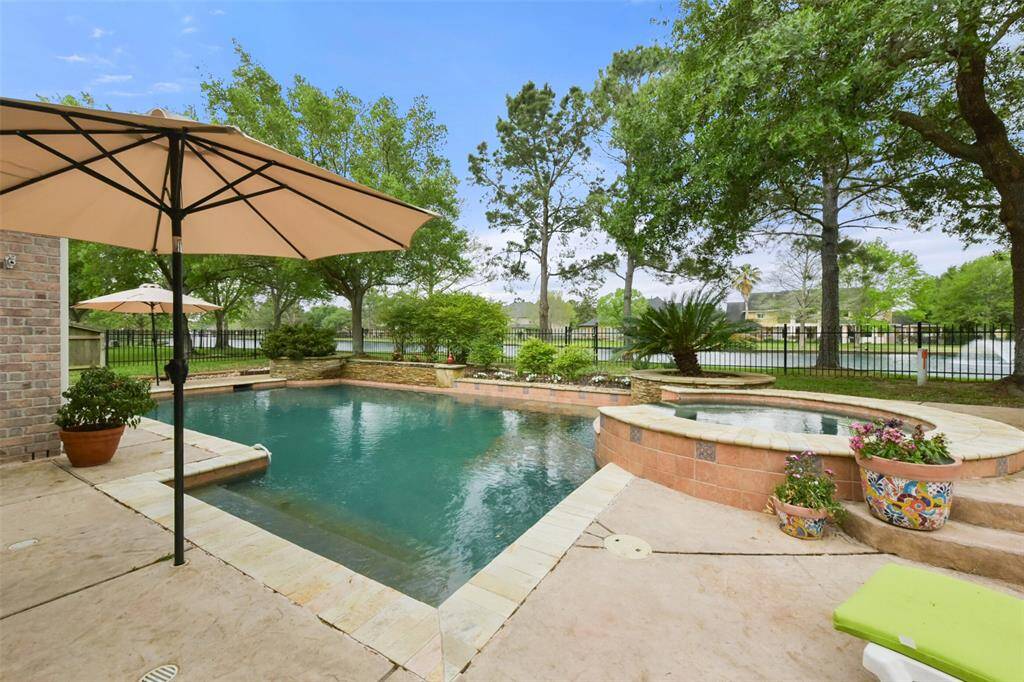 Your summer just got elevated with this beautiful saltwater pool and spa with bubblers and a waterfall. What a fun pool day!
