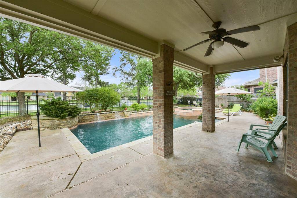 Extended covered back patio with fan offers tons of shade on those really hot summer days.
