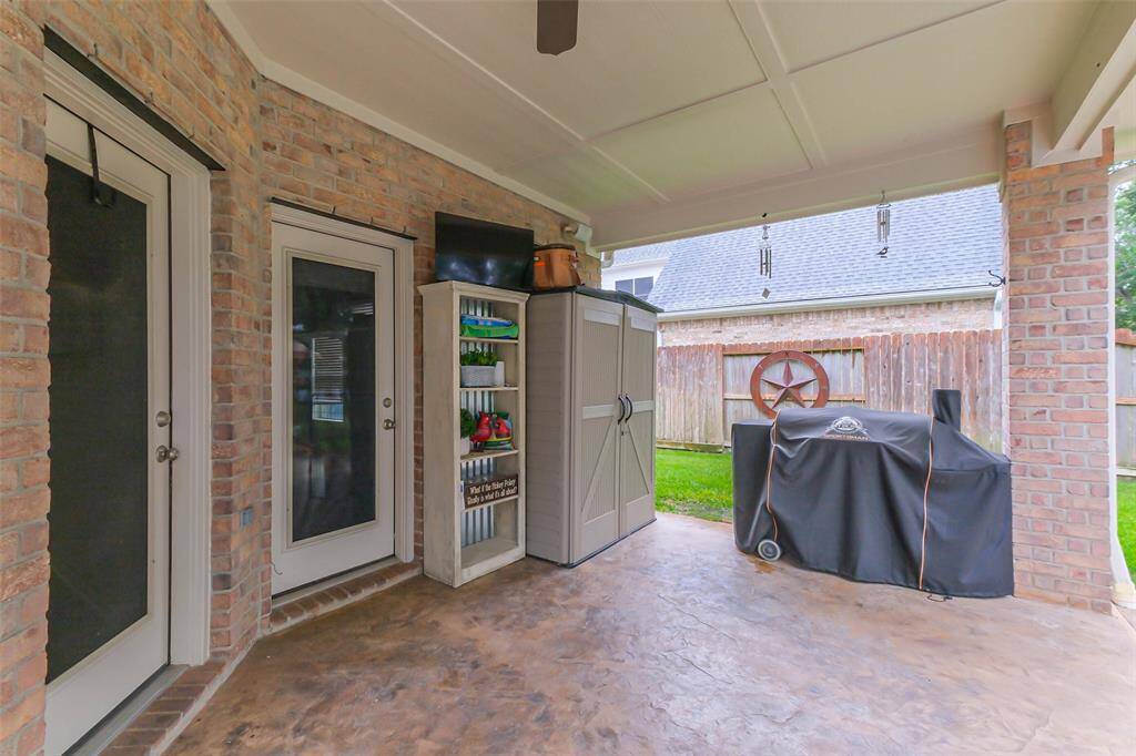 Another view of the covered patio. The door to the left gives you access into the kitchen. The other door gives you access into the tandem garage. This is very convenient to store your pool supplies/toys.