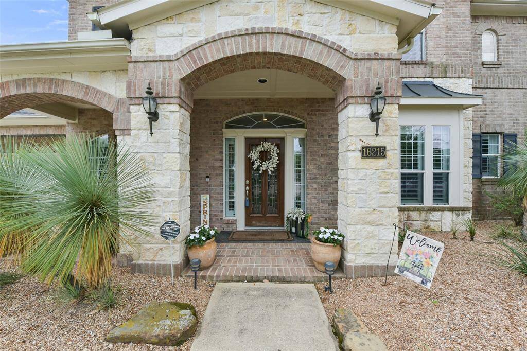Sought after stone and brick home with custom landscaping native to the hill country.