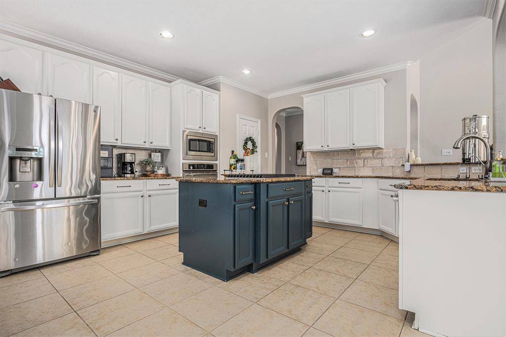 Kitchen with island with a gas cooktop