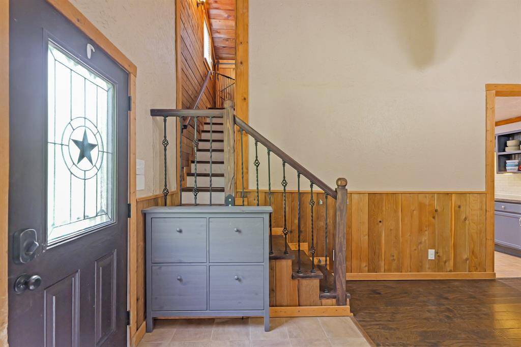 Front door entry with stairs leading to the upstairs primary retreat.