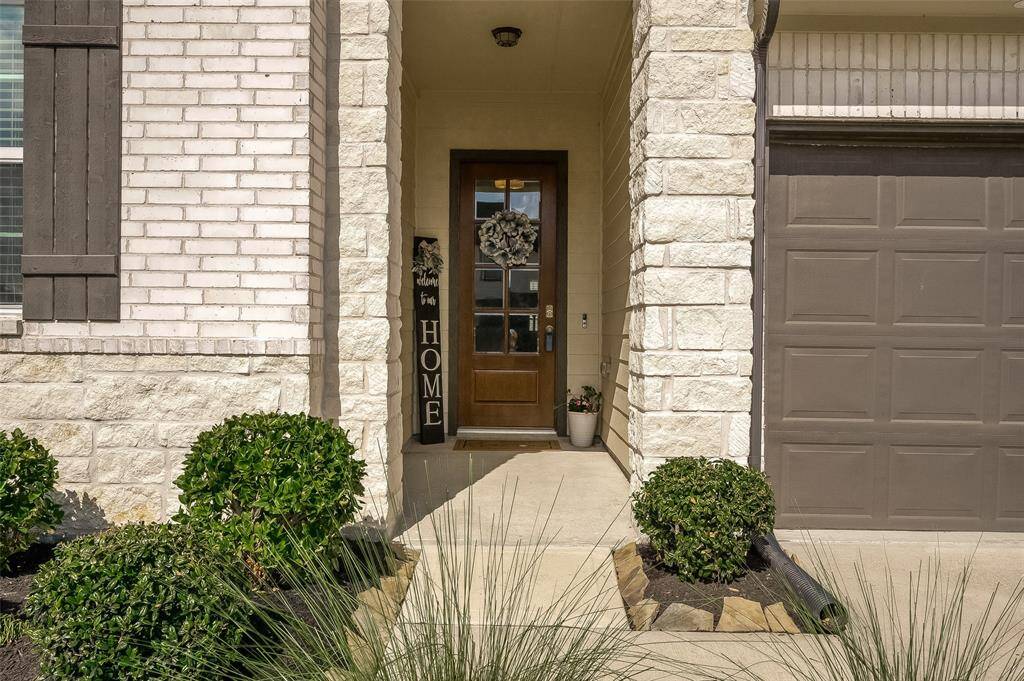 Beautiful brick and stone elevation with upgraded glass door entry.