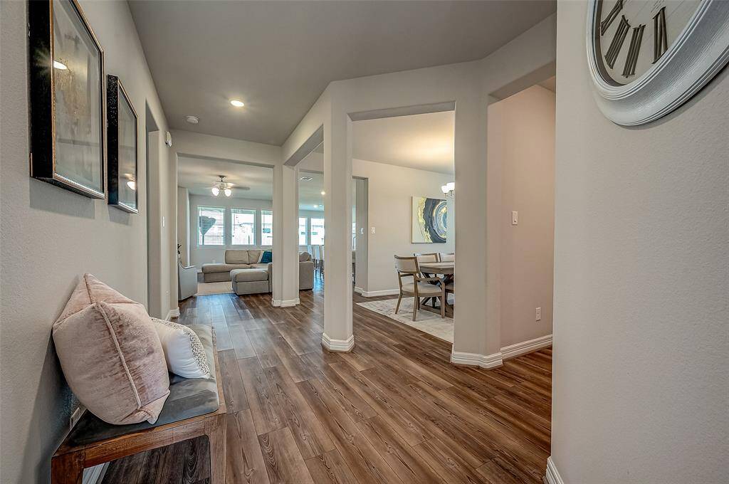Luxury Vinyl Plank flooring greets you upon entering the large open foyer with the spacious utility room to the right.