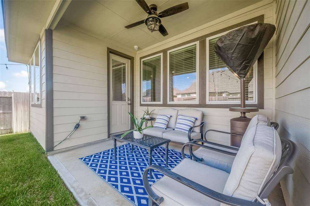 Nice sized covered patio with ceiling fan.