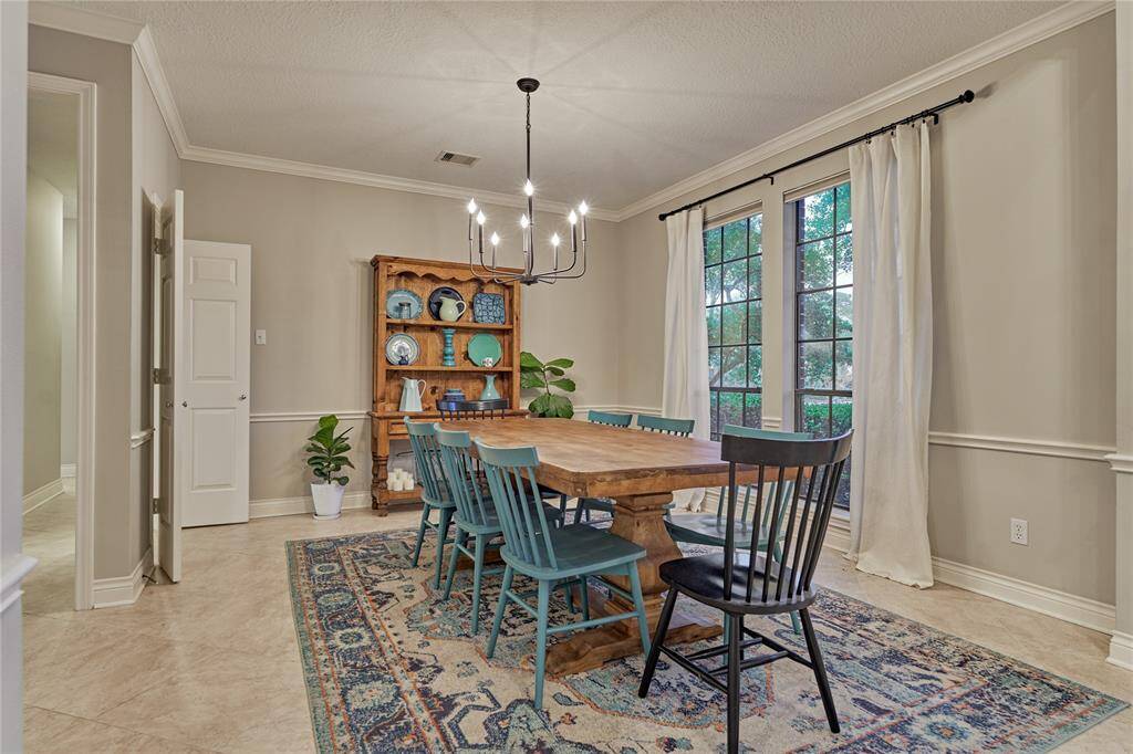 The elegant chandelier and  bright sunny windows keep the space light and bright.