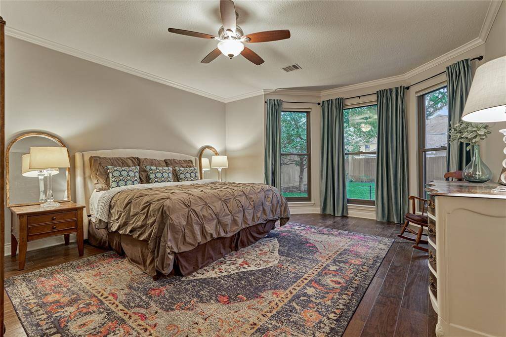 The primary bedroom is a quiet retreat that enjoys backyard views.
