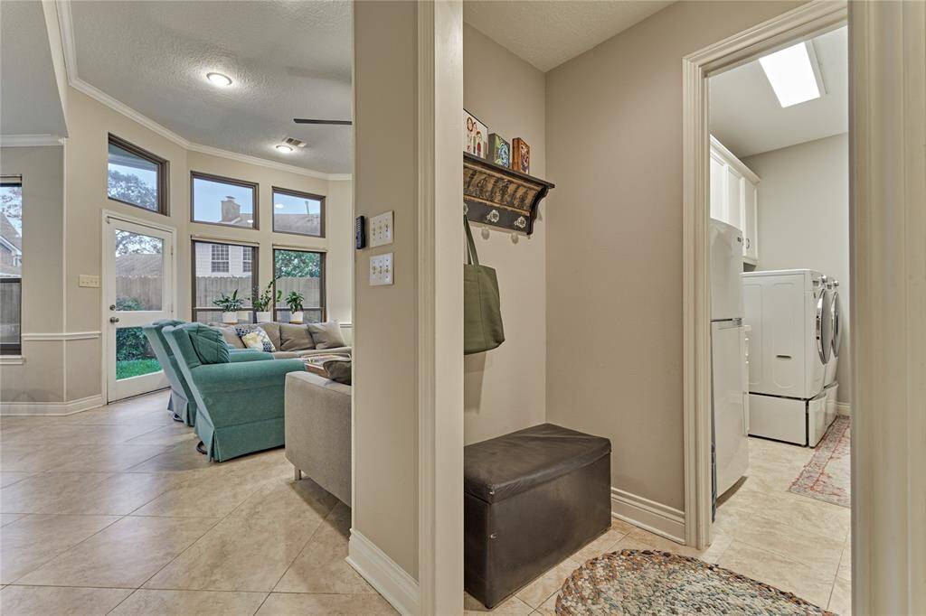 Just off of the living room into a private hall is the laundry room and access to the garage.