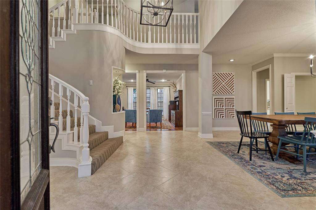 The impressive two-story foyer with spiraling staircase creates quite a dramatic entrance.