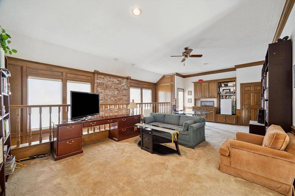 JOURNEY UPSTAIRS TO THE GAMEROOM WITH BUILT-INS, VAULTED CEILING, AND PLUSH CARPET.