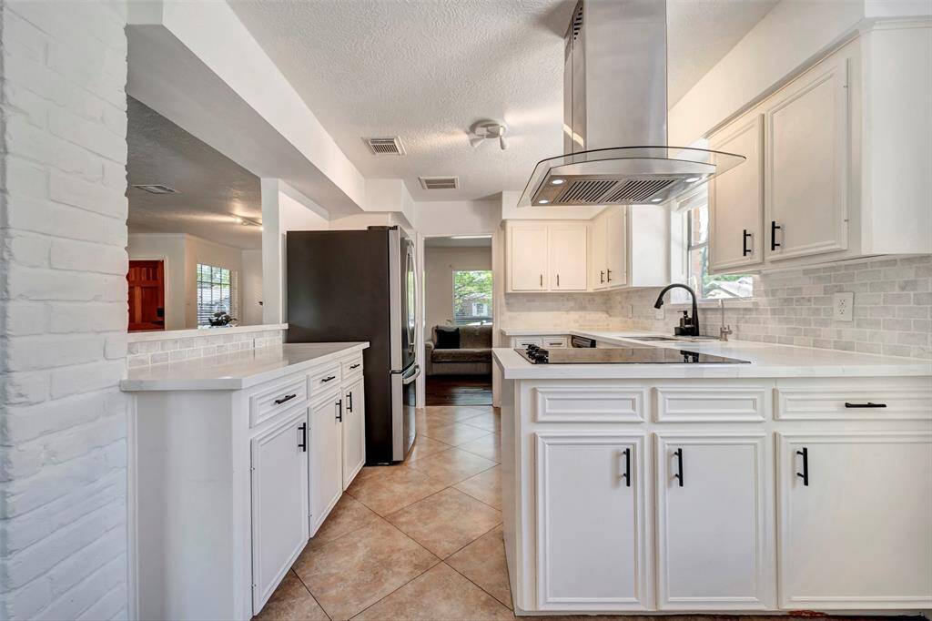 A look at the kitchen from the breakfast room. From here you can see how there is a breakfast bar on the left that overlooks into the family room.