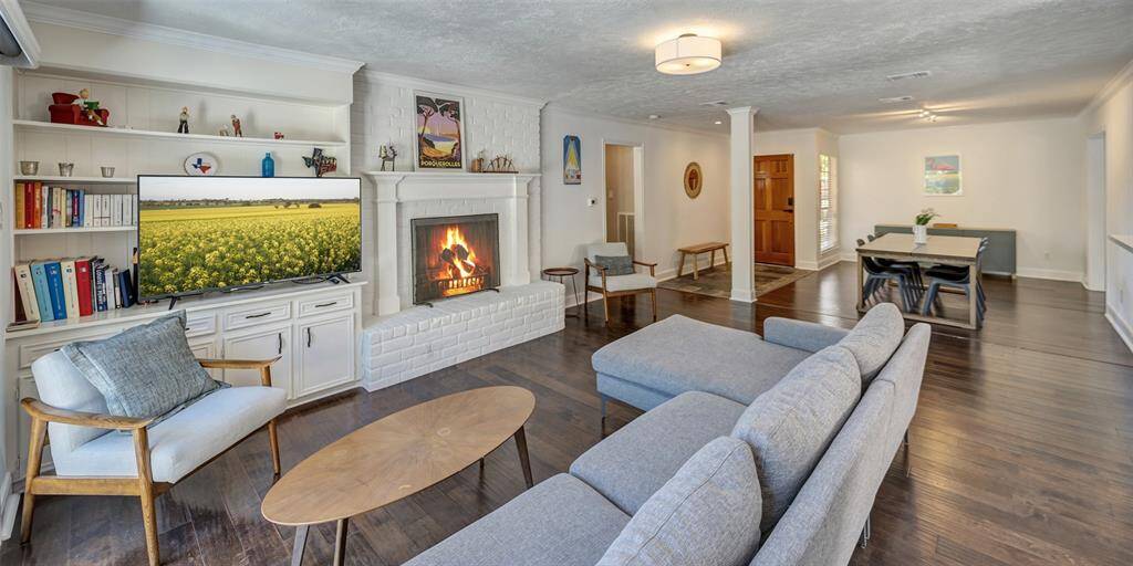 The spacious family room showcases a stunning wood burning fireplace and built-ins.
