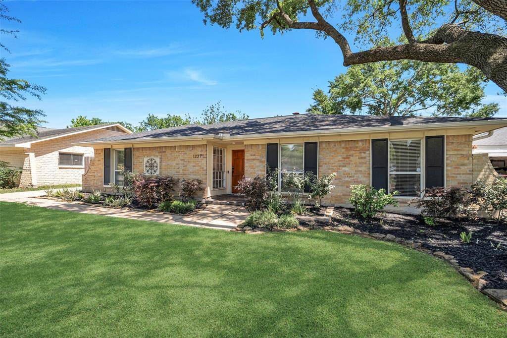 With its stone-lined garden beds, mature oak tree, and lush green grass - this home boasts curb appeal!