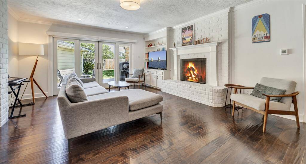Plenty of sunshine, a cozy fireplace, and a view that invites you straight out to the backyard - this family room gives off such a warm and welcoming feel!