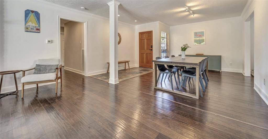 Gorgeous engineered wood floors throughout the home. The hallway pictured on the left leads to the bedrooms.