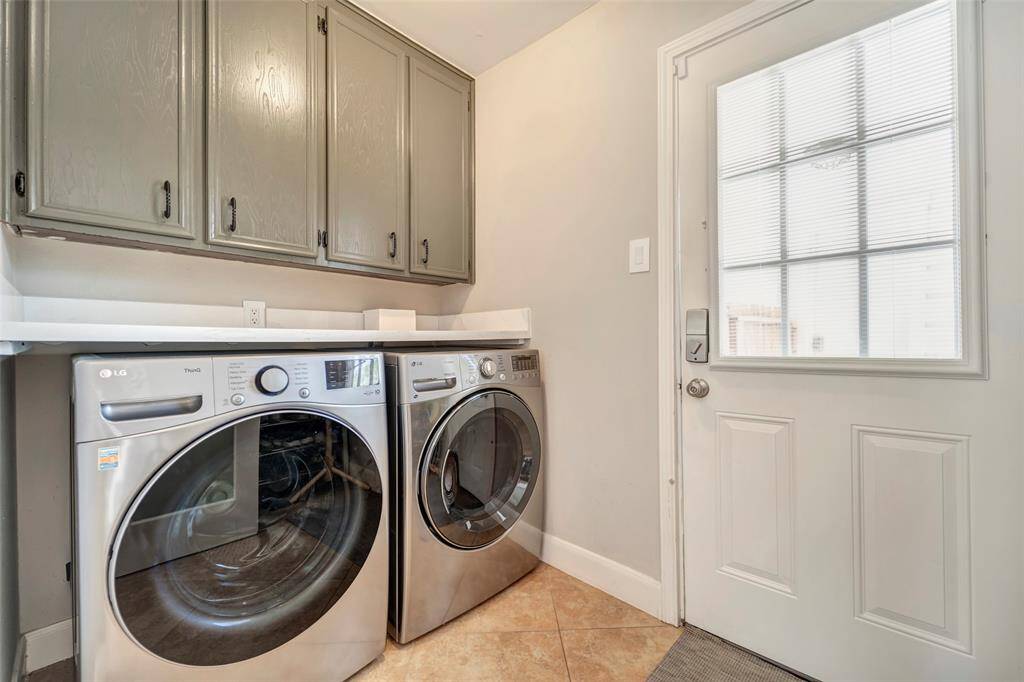 The utility room is off of the breakfast room and kitchen. It has a large countertop space above the high end stainless steel washer and dryer set. All appliances are to remain with the home.