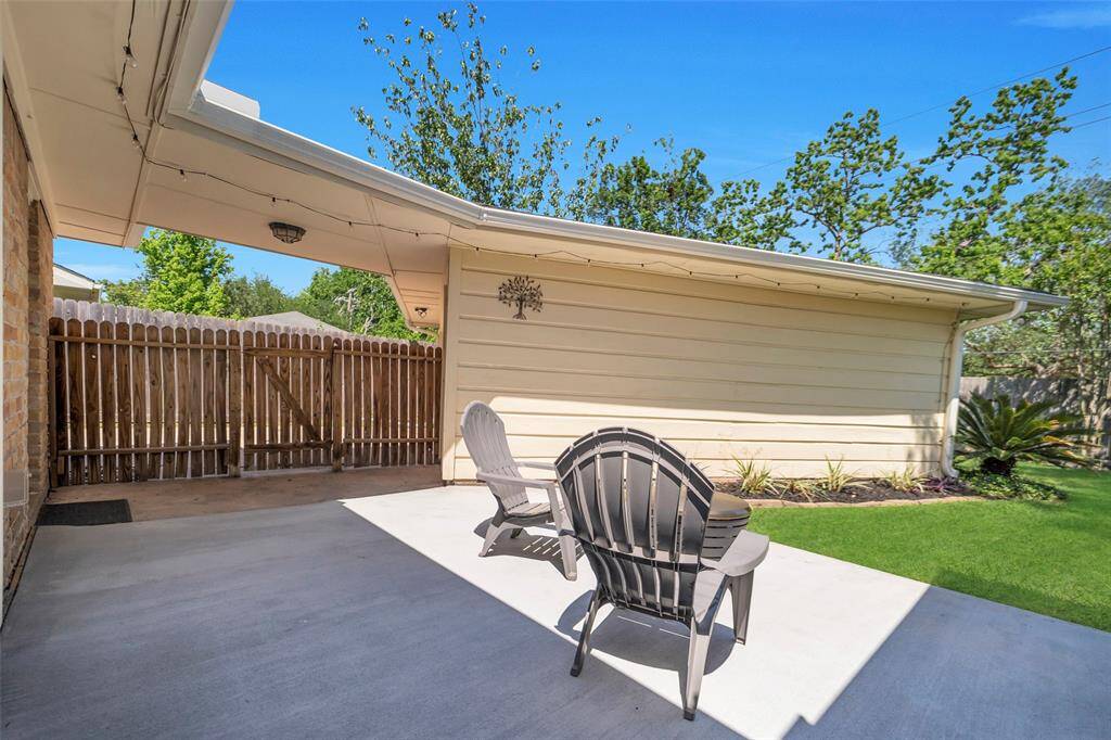 Another look at the back patio space. The gate pictured offers convenient access to the driveway.