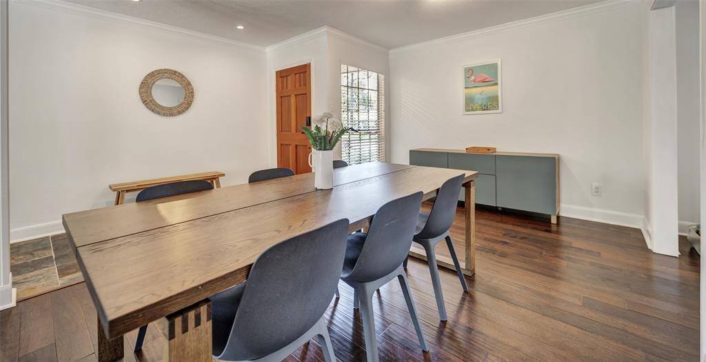 To the left of the entryway, you will find the formal dining room. Take a look at the breathtaking engineered wood flooring that you will see throughout the home.