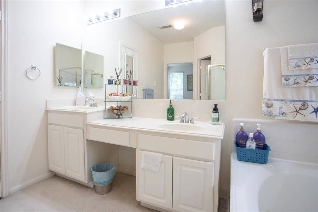 Primary Bath with Dual-Height Countertop Vanities.